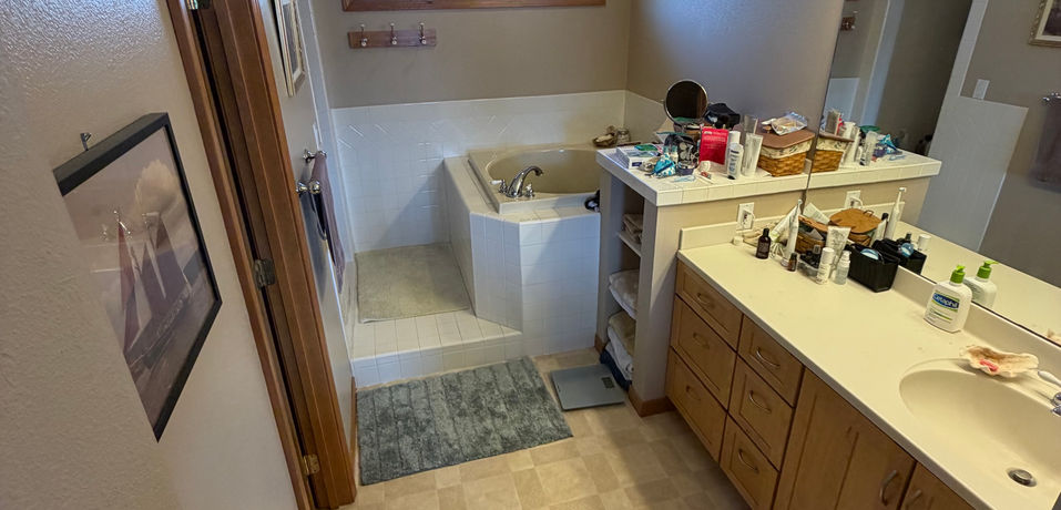 The main bathroom has a walk in shower, toilet closet and soaking tub