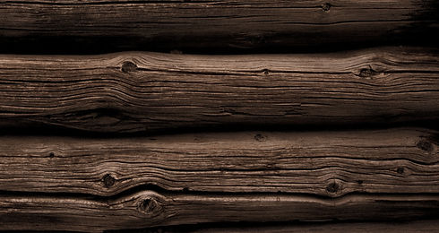 Close-up of dark weathered logs on one of the Quiet Shelters log cabins in Kanab, Utah