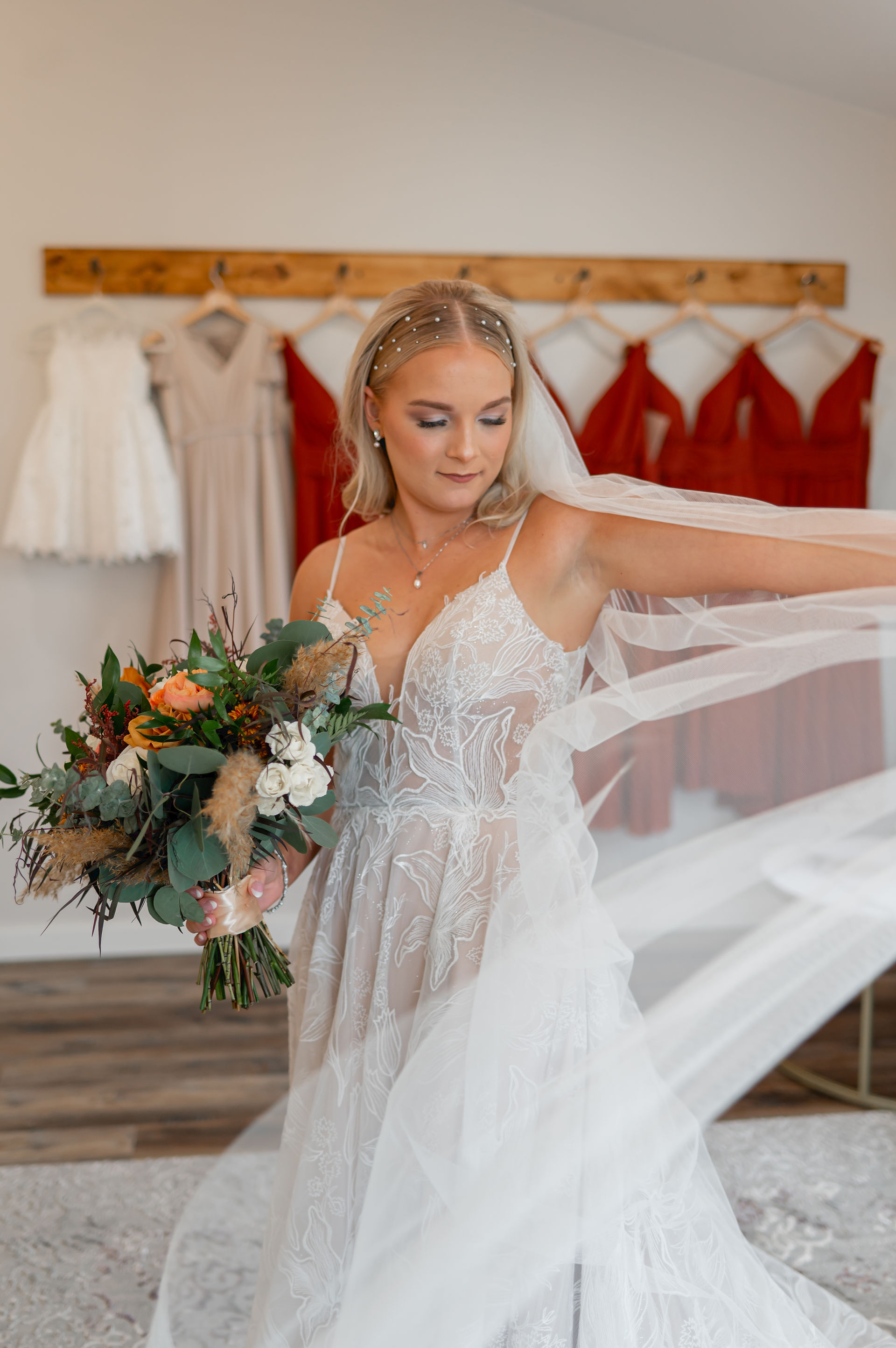 Bride dressed in white with veil and flowers in the spacious bridal suite