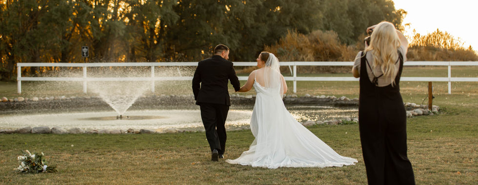 Behind-the-scenes look at Minnesota wedding photographer Brittany Maasch capturing bride and groom portraits near the pond at 5 Family Ranch in Southwest Minnesota.