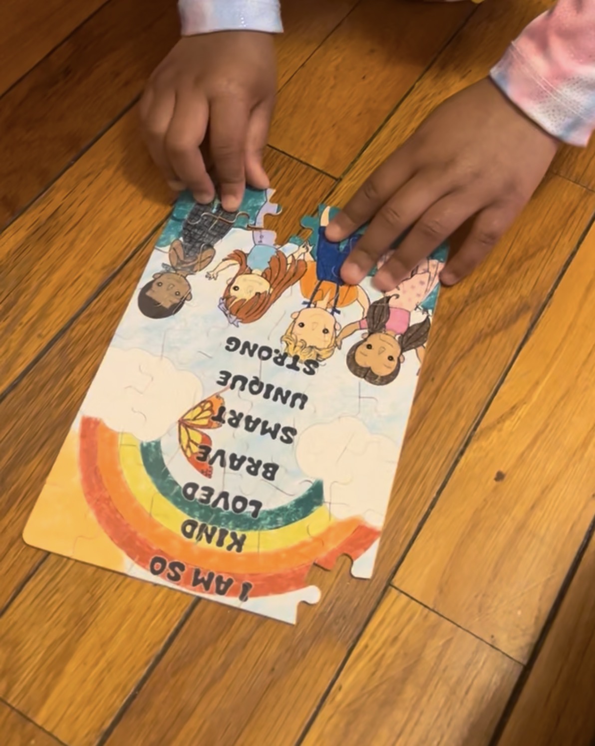 Child putting together the I AM SO affirmation puzzle