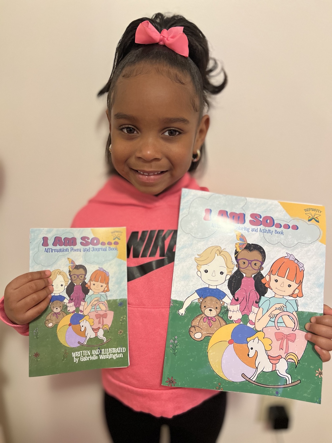 Child holding the I AM SO books