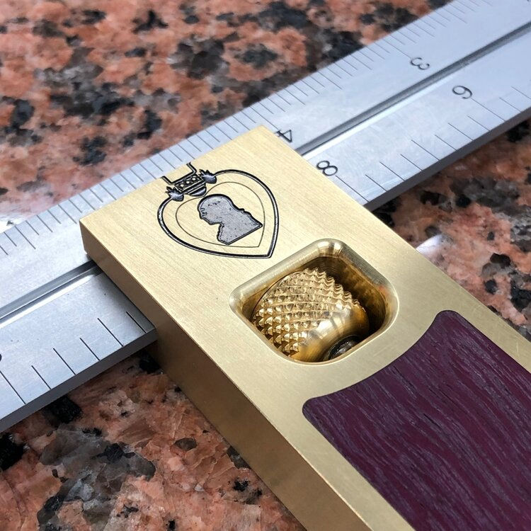 12" brass with Purpleheart inlay and custom engraving.