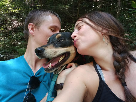The author and her partner kissing their dog