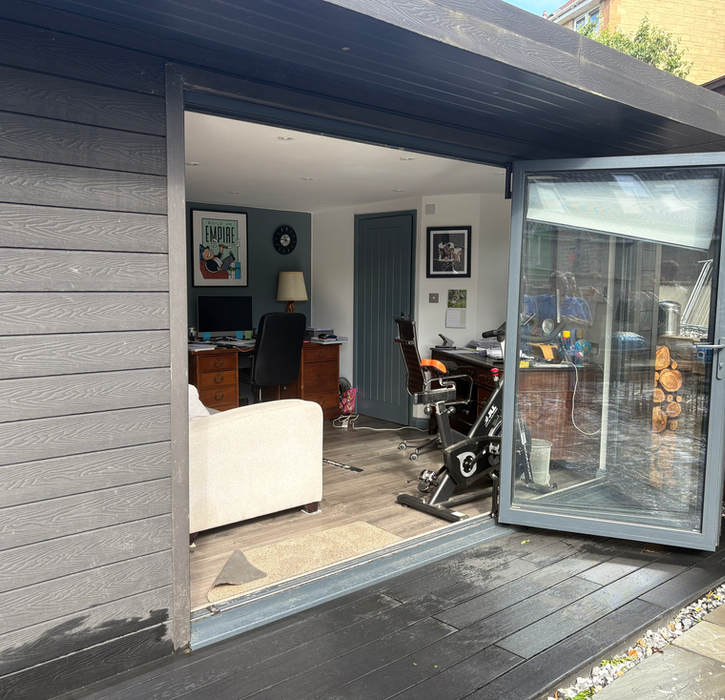 Contemporary garden office with canopy and decking area