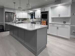 A large kitchen featuring white cabinets and a central island, recently refaced in North Andover, MA.