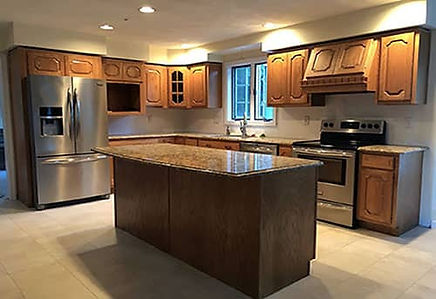 An outdated honey color oak kitchen