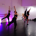 Dancers reaching on one leg in warmup