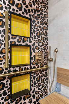 Leopard tile shower with yellow tile feature shelving