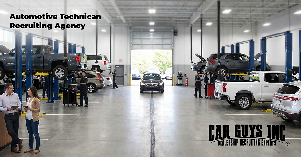 Automotive technicians working in a modern dealership service bay during active vehicle repair.