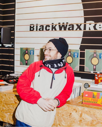 A man leaning back on vinyl records