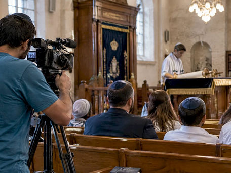 Videographer records a Bar Mitzvah ceremony