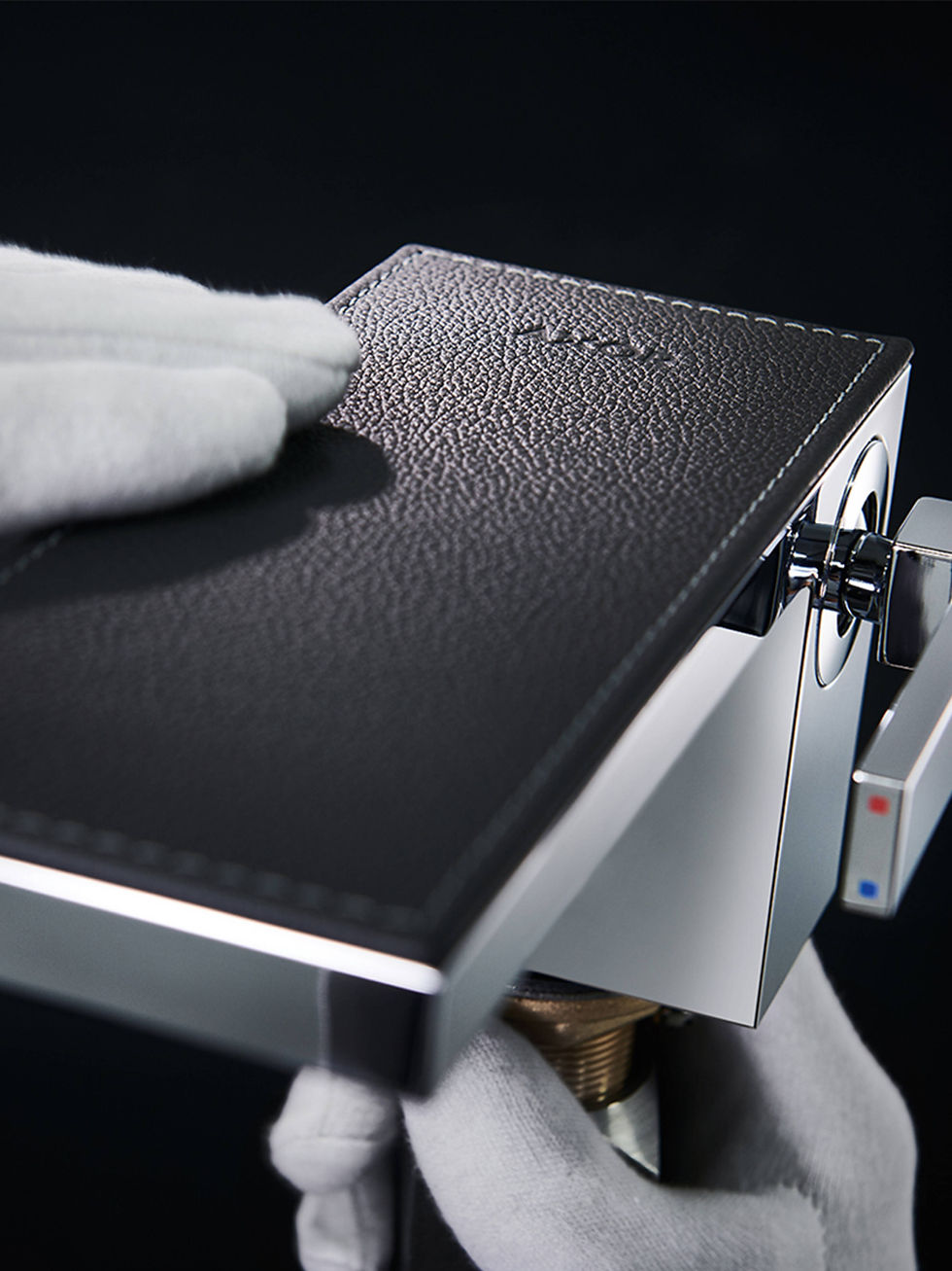 Gloves touching luxury German made tapware by AXOR MyEdition.