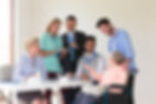 Professional people gathered around an elderly person who is sitting
