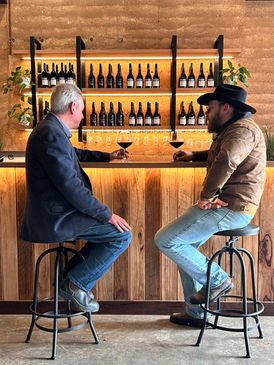 2 men sat at the cellar door bar drinking wine at wedgetail estate