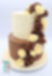 two tiered cake draped with edible flowers 