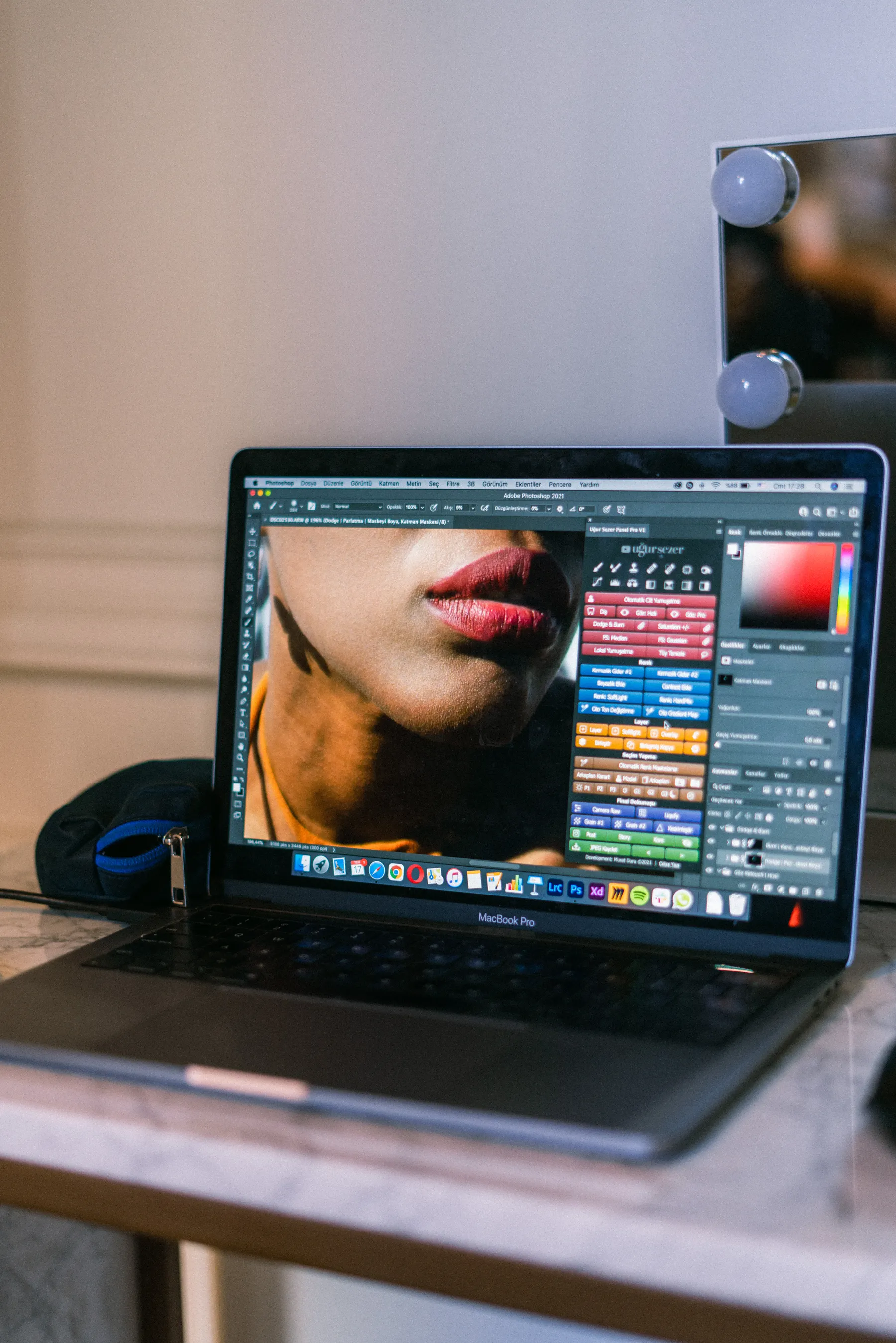 A laptop displays a visual design workspace.