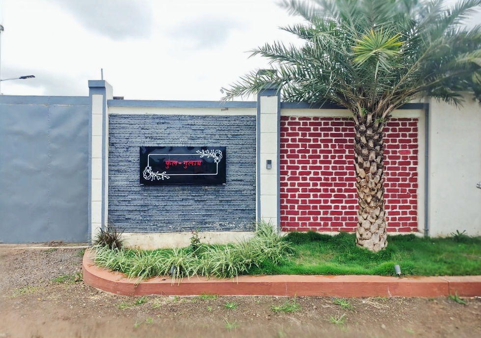 The lush, manicured garden at Fulgulab Lawns & Homestays, featuring vibrant flowering plants and greenery with a view of the Sahyadri mountains, perfect for a peaceful outdoor retreat