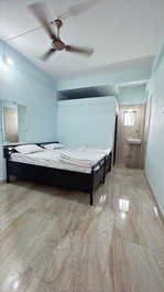 Beds with bedding and good lighting at Fulgulab Lawns & Homestays