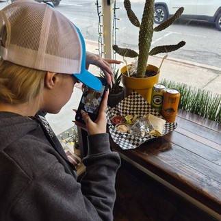 person taking the photo at the counter of food