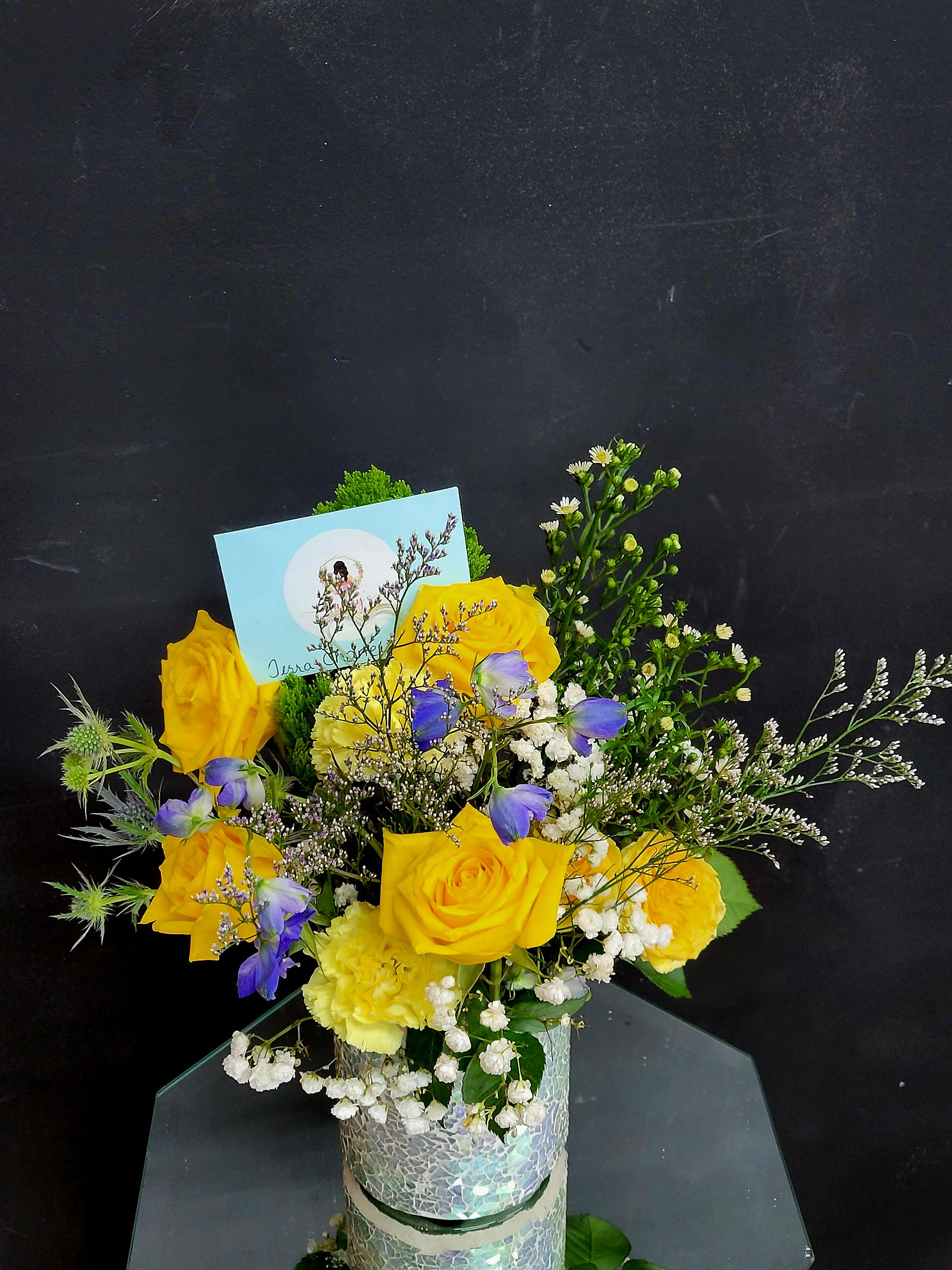 Yellow rose and carnations with hint of blue