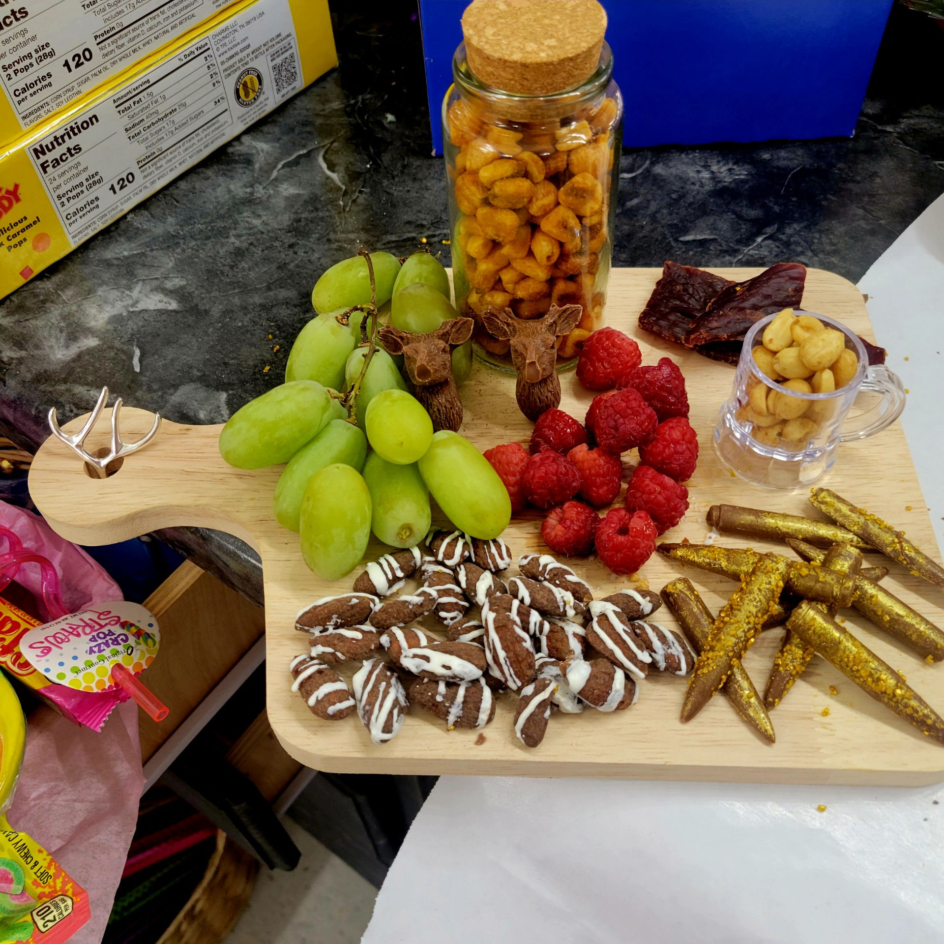 Men snack tray: fruit, nuts, jerky, chocolate, deer, bullets