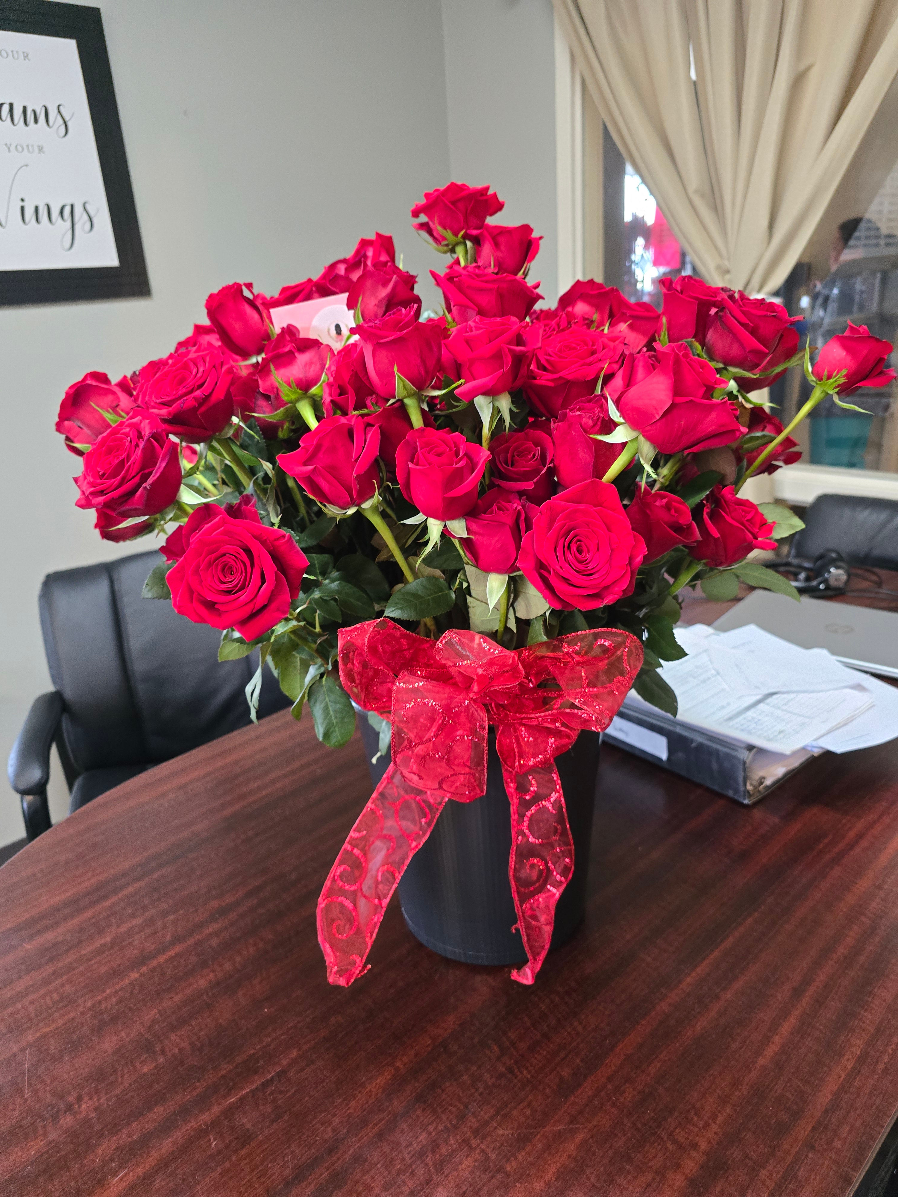100 Long stemmed red roses (available in red, white, or pink). Please specify 
