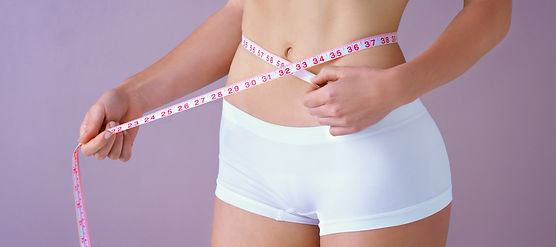 Woman, body and waist with tape measure in studio for diet, progress and tracking of weigh
