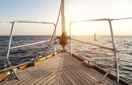 View from yacht's bow sailing towards horizon (skyline) at sunset, serene sunrise scene. S