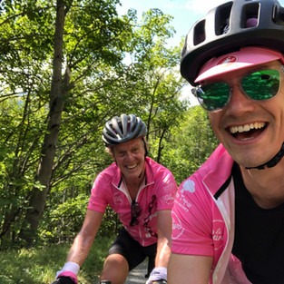 selfie of cyclists riding up mountain