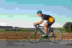 a man, cycling on a country road