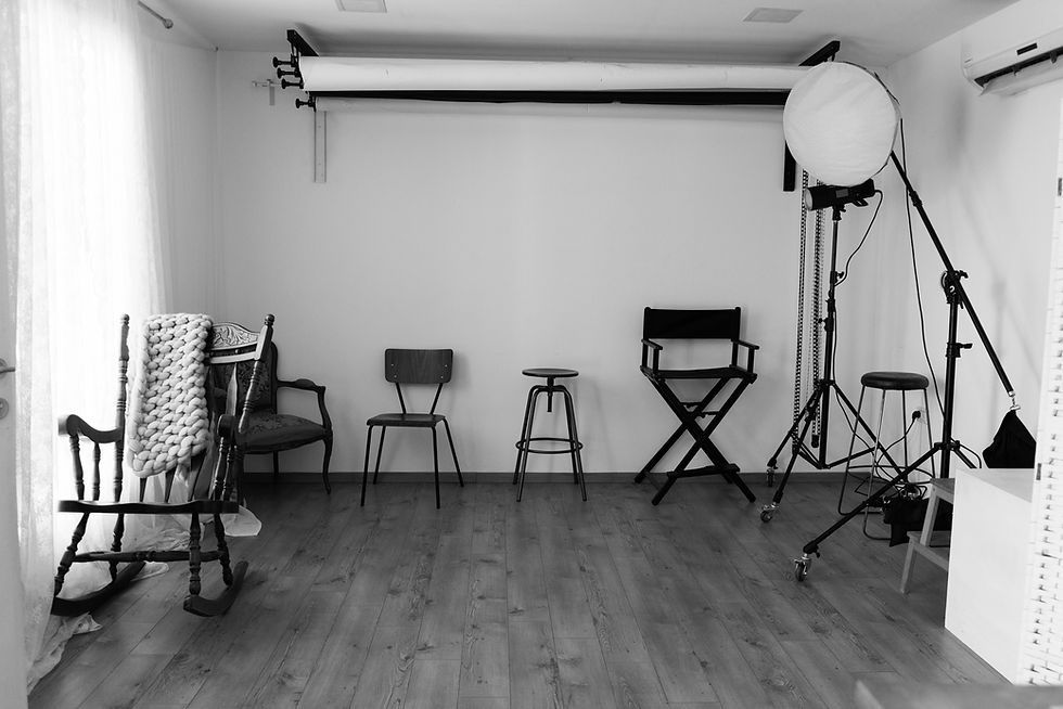 Close-up view of a camera on a tripod in a bright photography studio