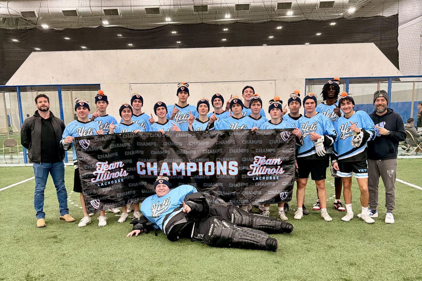 Yeti high school team holding a champions banner