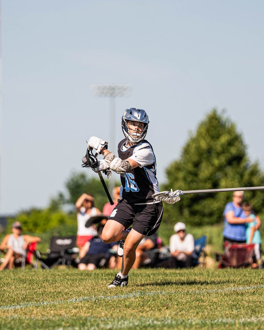 Yeti attackman dodging with spectators behind