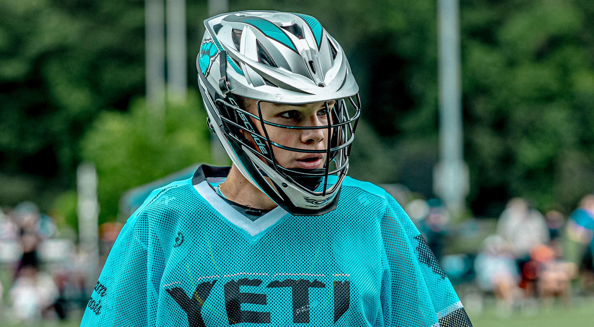 Yeti player in a teal jersey on the sideline