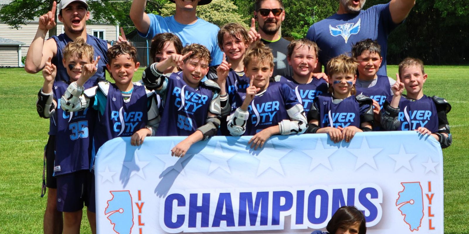 River City youth team celebrating with a champions banner
