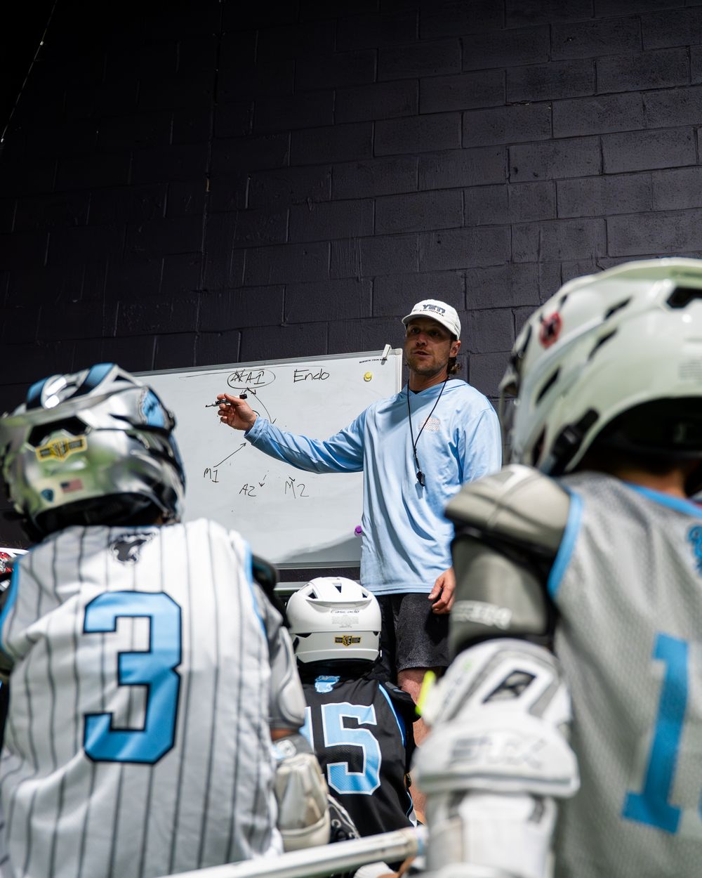 Yeti coach teaching young players at a whiteboard