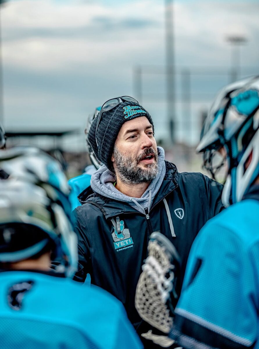 Yeti coach talking to players in a huddle