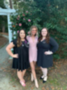 Students (from left to right) Madison Thum, Kathryn Bachman, and Autumn Thompson posing in formal wear with stethoscopes on.