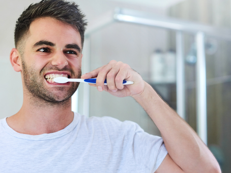 Man brushing his teeth in the bathroom