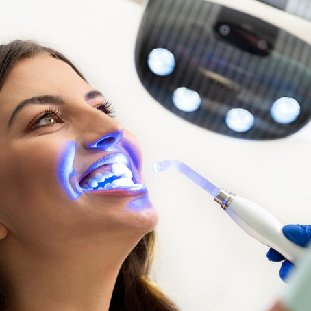 Woman receiving in-office teeth whitening treatment at a dental clinic