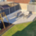 Porcelain patio with a raised K-render wall and a rubber barked play area.