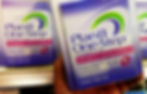 Photograph of a person holding a package of Plan B emergency contraception in the aisle of a store