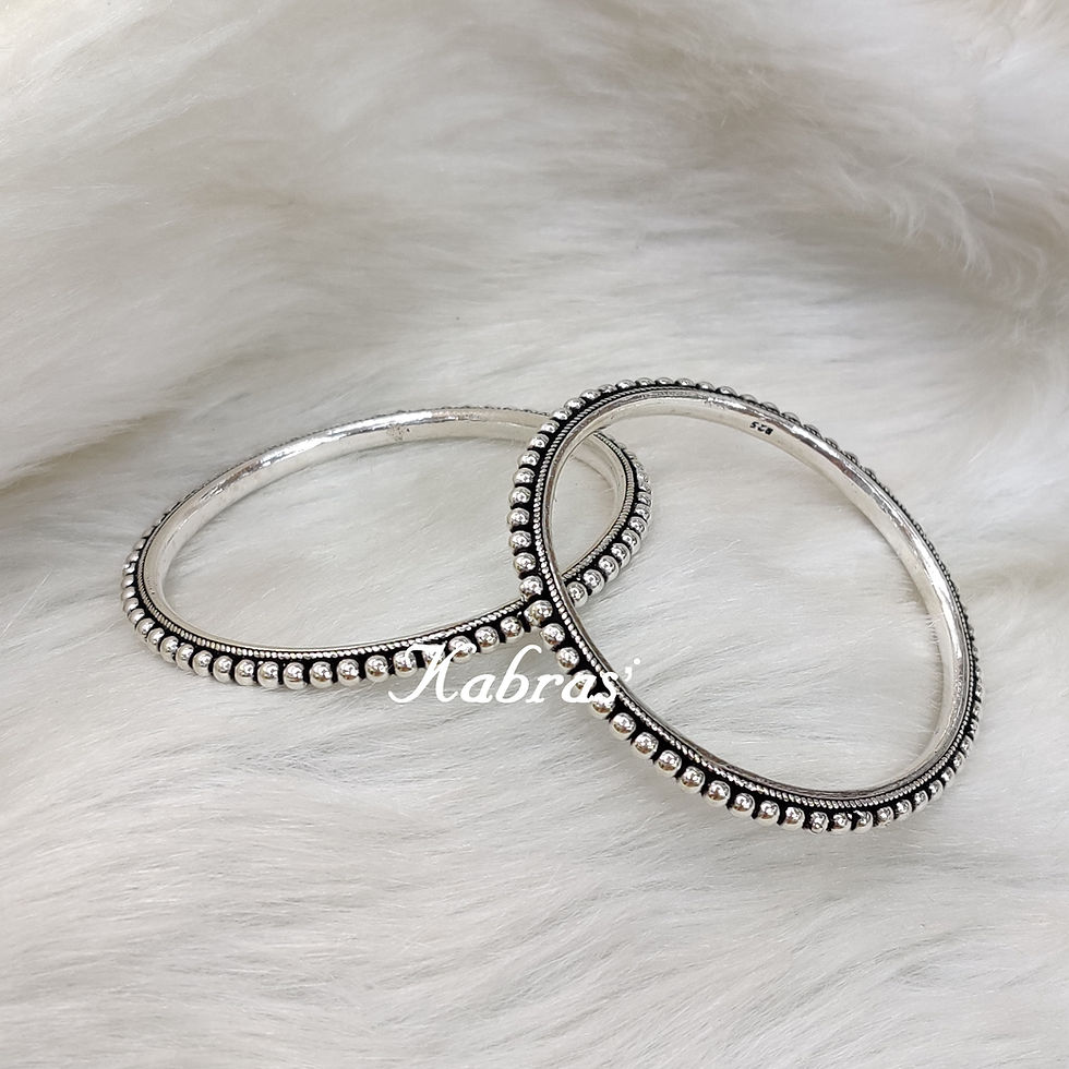 Thumbnail: Add a touch of classic sophistication to any outfit with these gorgeous silver bangles.