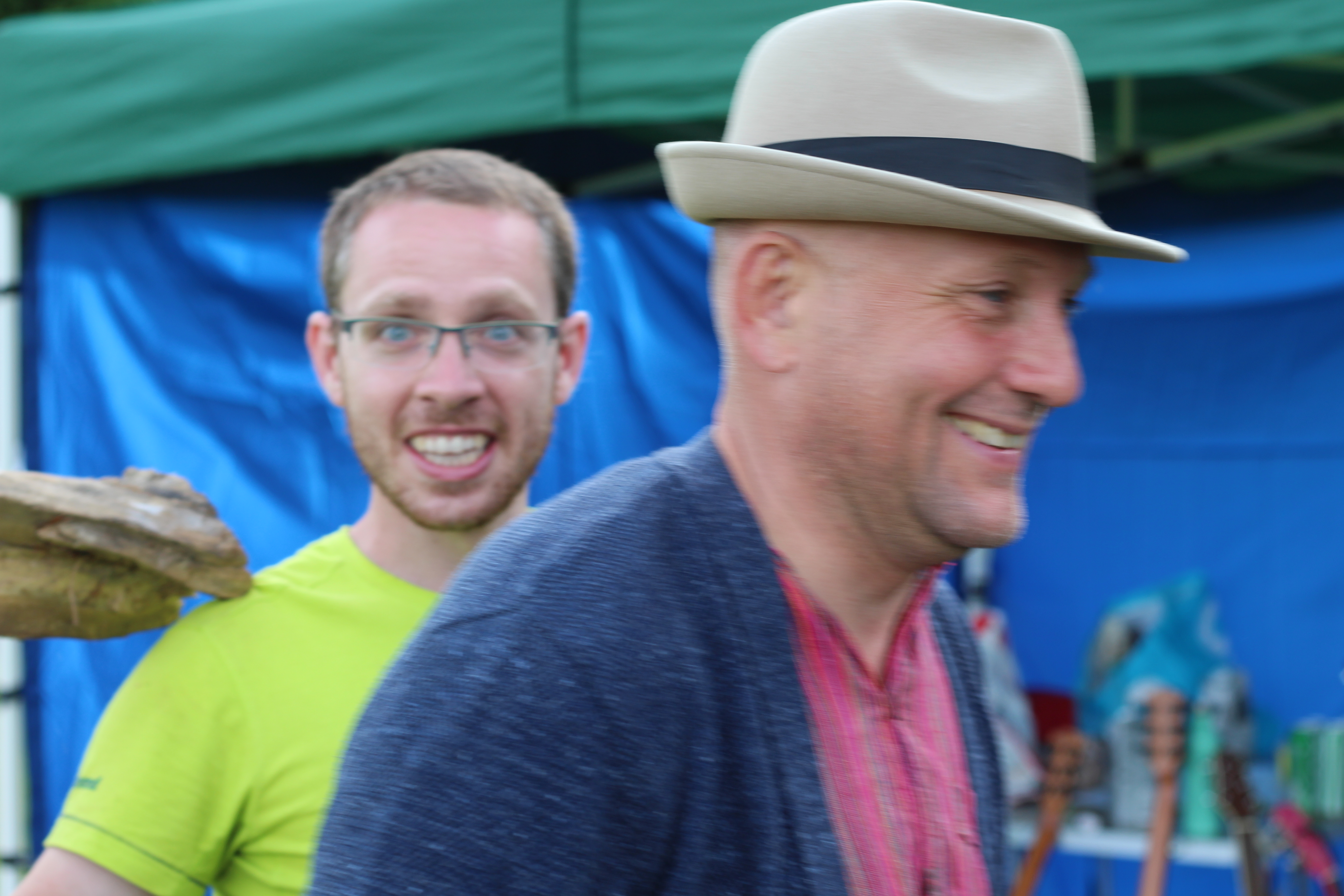 Man with hat passes cardboard cutout