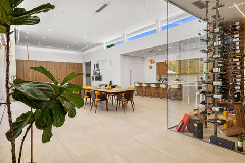 Luxury new build home dining area complete with a glass wine room