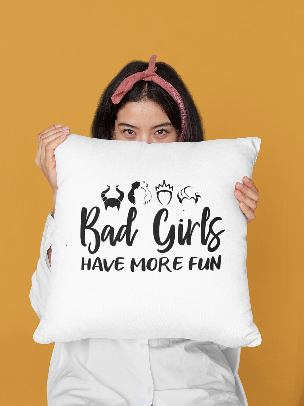 Woman holds 'Bad Girls Have More Fun' villain pillow