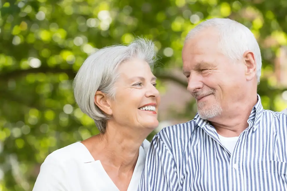 Elderly couple smiling together outdoors, symbolising dignity and family connection in capacity for residency decisions.