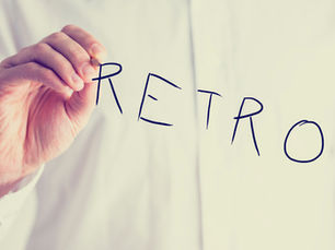 A person writing retro on a mirror