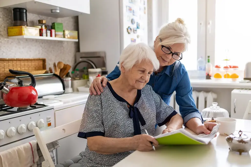 An elderly woman with white hair shares a quiet, supportive moment with a younger woman, representing compassion and dignity in trustee capacity assessments